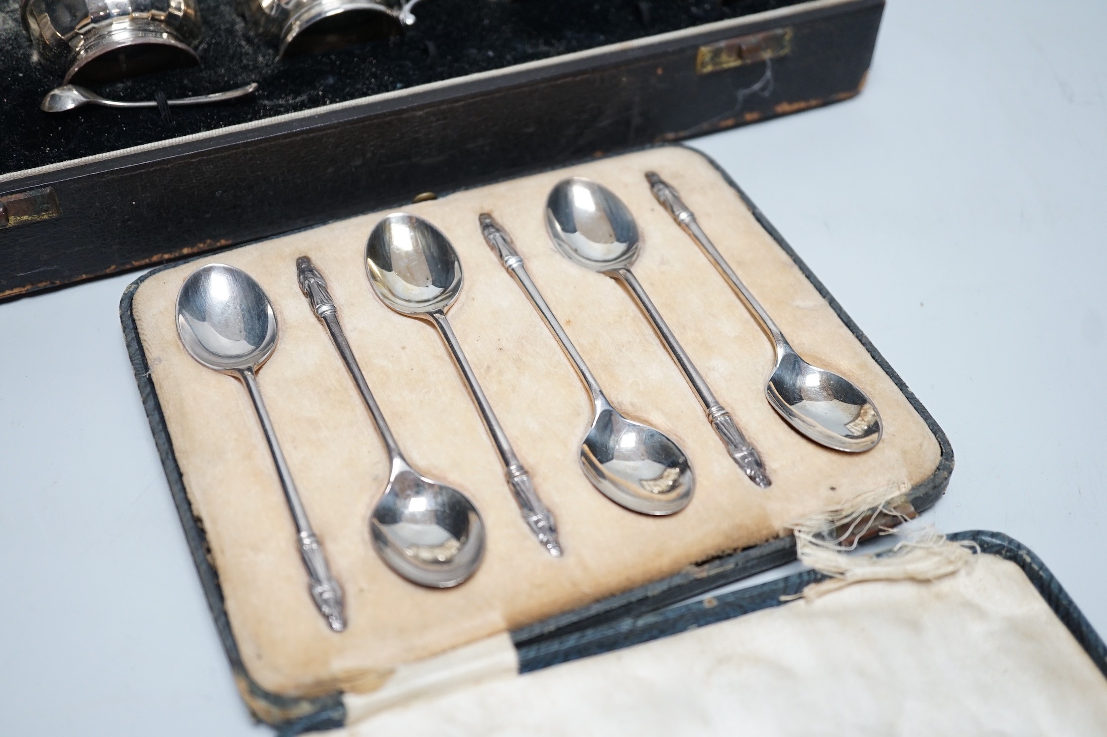 A cased George V ten piece silver condiment set, with four (ex 6) spoons, maker, RR, Birmingham, 1936 and London, 1929, together with a cased set of six silver teaspoons.